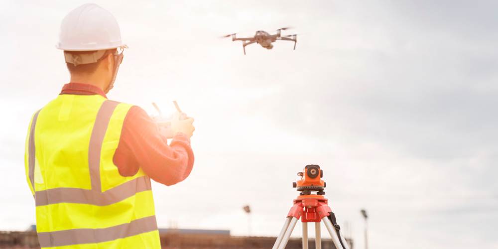 engineer working at construction site with drone over construction site