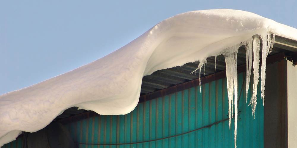 roof of a structure with snow hanging from it